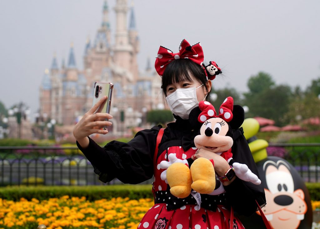 A visitor dressed as a Disney character takes a selfie while wearing a protective face mask at Shanghai Disney Resort as the Shanghai Disneyland theme park reopens following a shutdown due to the coronavirus disease (COVID-19) outbreak, in Shanghai, China May 11, 2020. REUTERS/Aly Song TPX IMAGES OF THE DAY