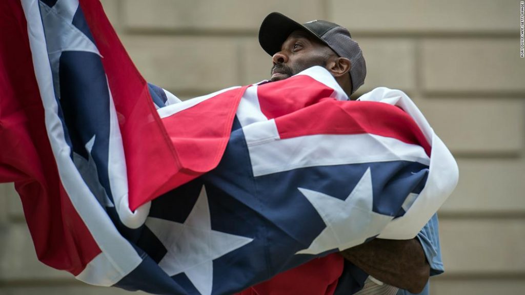 Mississippi governor signs bill to retire flag with Confederate emblem
